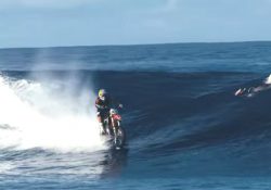 Rides dirt bike on the powerful waves